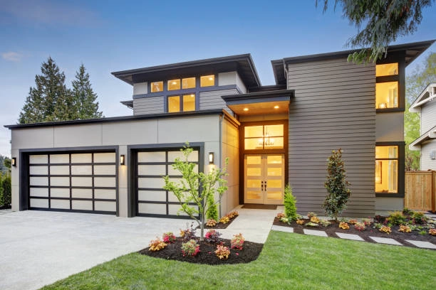 Modern style home boasts two car garage spaces with glass folding doors